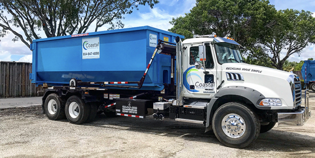 Dumpster loaded on truck in Coastal Waste's Yard in Pompano Beach, FL