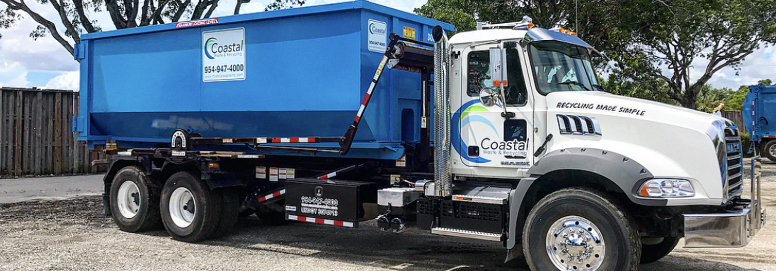 Dumpster loaded on truck in Coastal Waste's Yard in Pompano Beach, FL